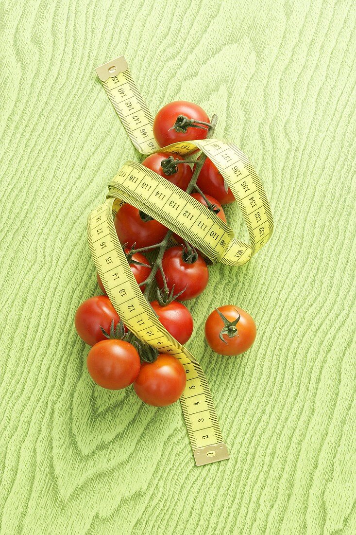 Cocktail tomatoes with a tape measure