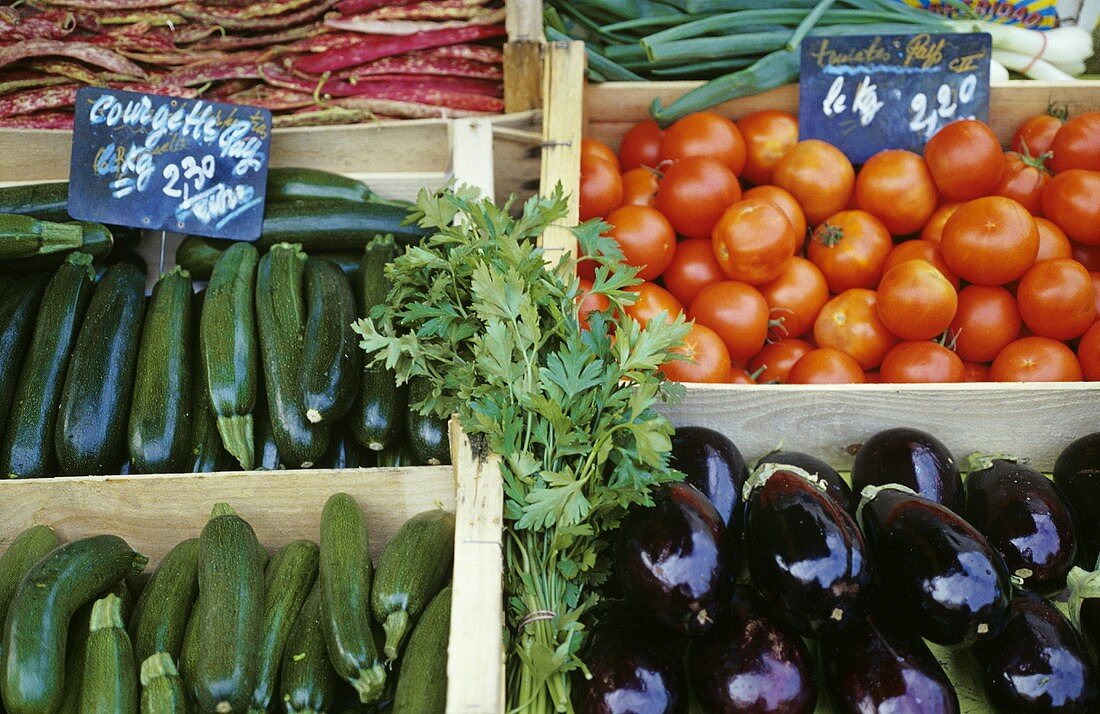 Courgettes, aubergines, tomatoes on a market stall in Provence