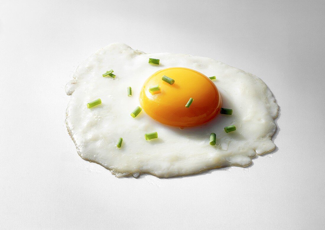 A fried egg sprinkled with chives