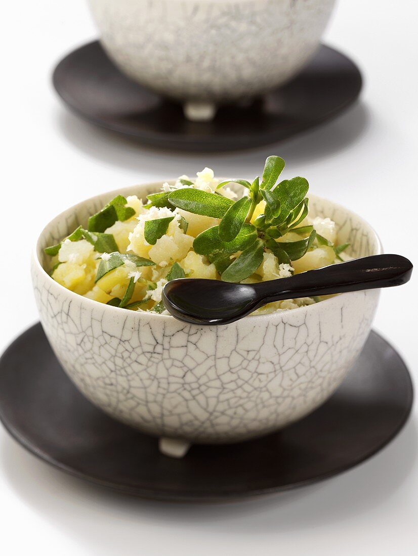 Roughly mashed potatoes and parsnips with purslane