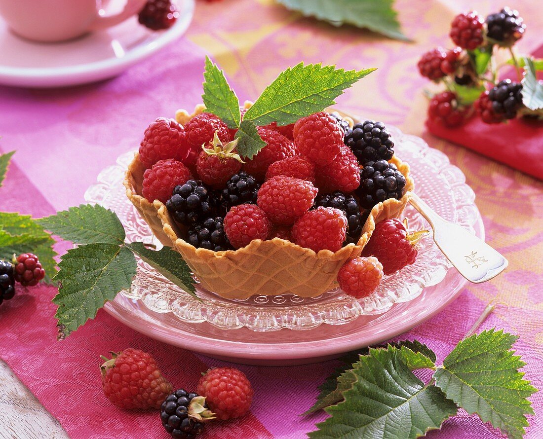 Fresh raspberries and blackberries in waffle bowl