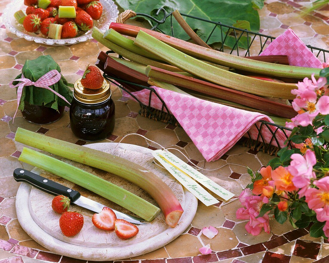 Rhubarb in basket & on chopping board, strawberries & roses