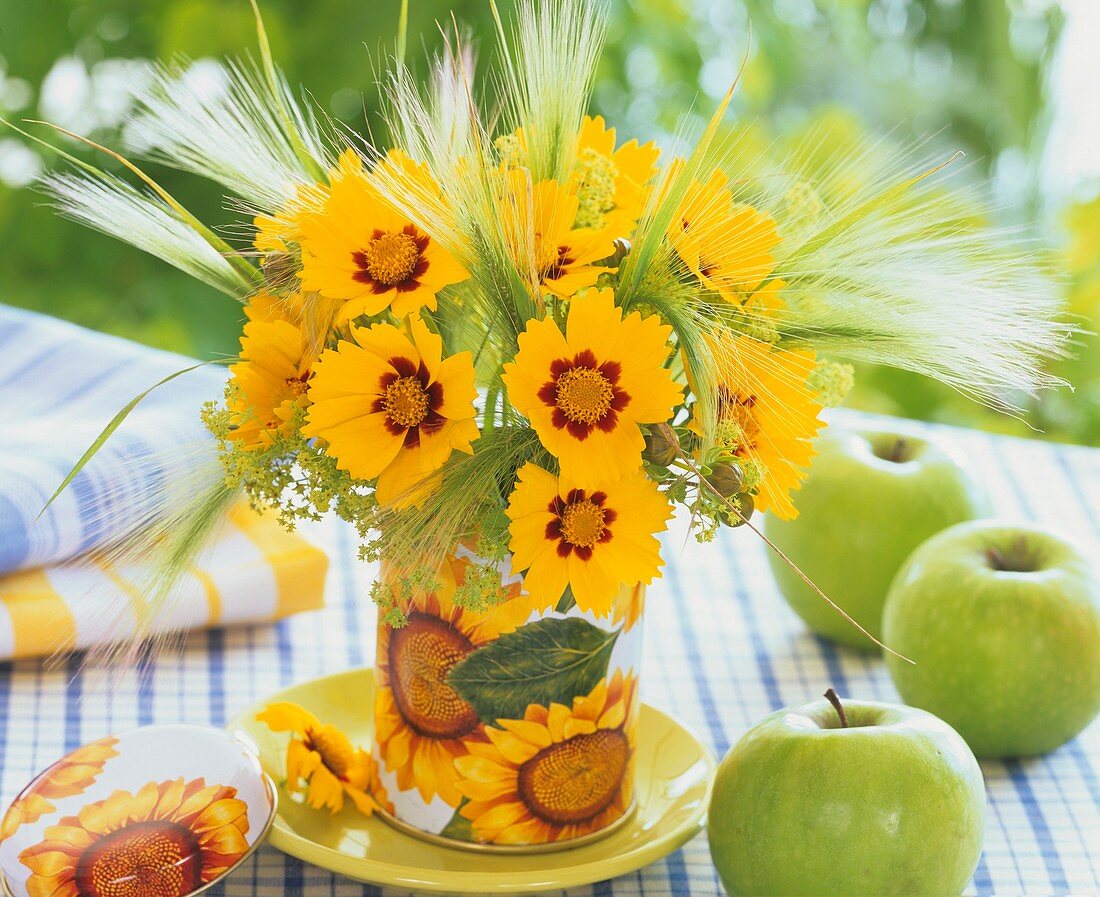 Small arrangement of coreopsis, barley and lady's mantle