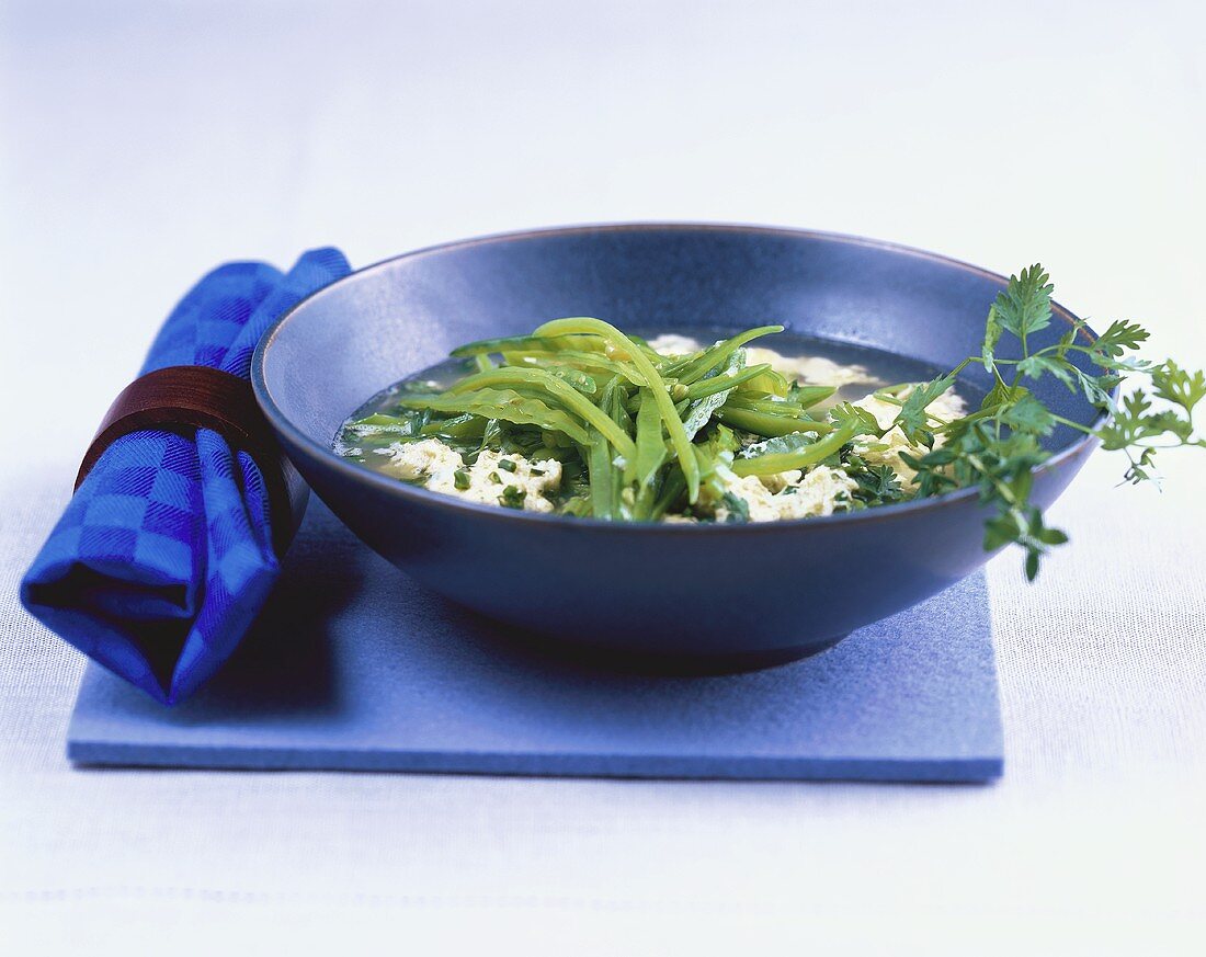 Herb broth with mangetout peas