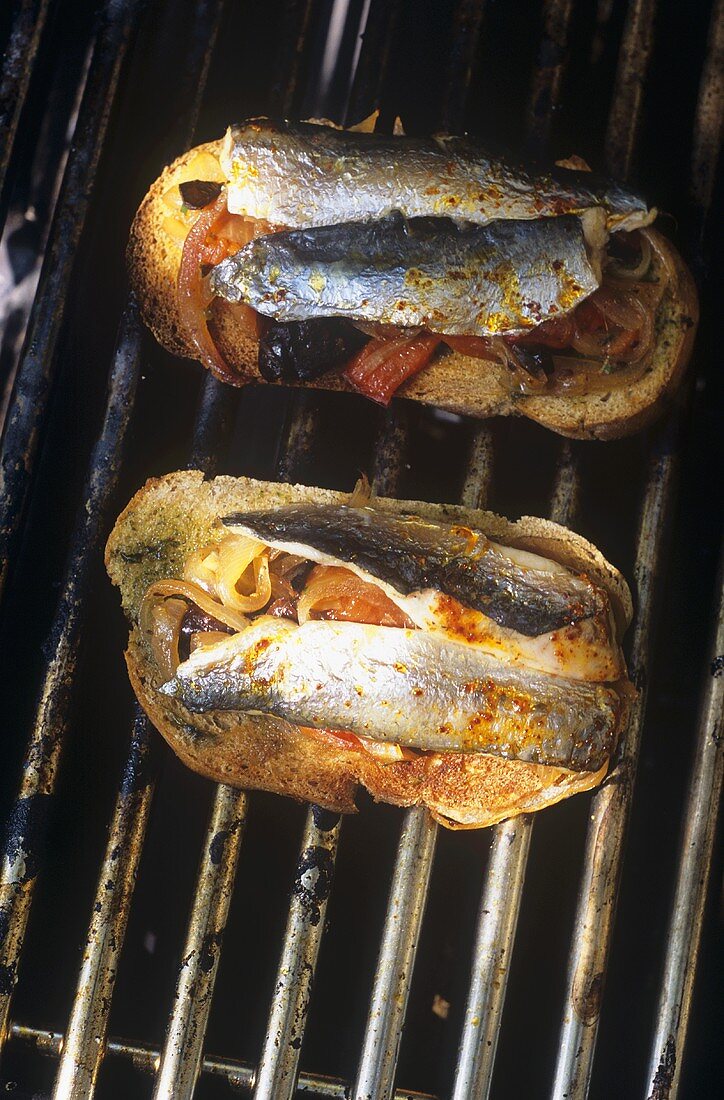 Slices of bread topped with fish on the barbecue