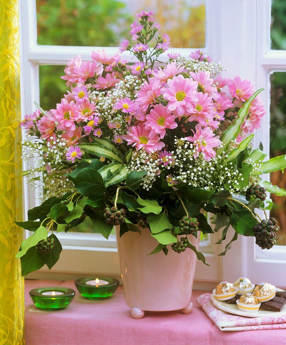 Vase of chrysanthemums, Michaelmas daisies and gypsophila
