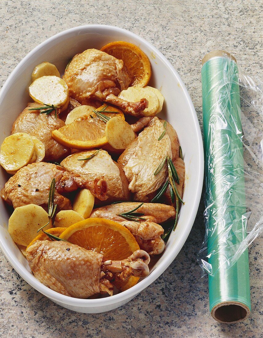 Chicken with oranges, potatoes and rosemary (still raw)