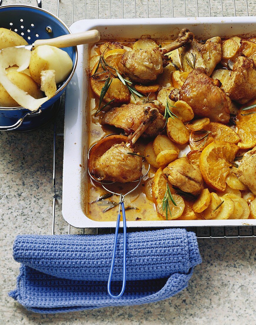 Chicken with oranges, potatoes and rosemary, oven-roasted