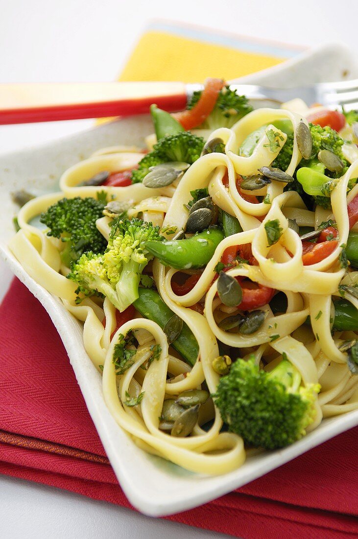 Pasta salad with vegetables and pumpkin seeds