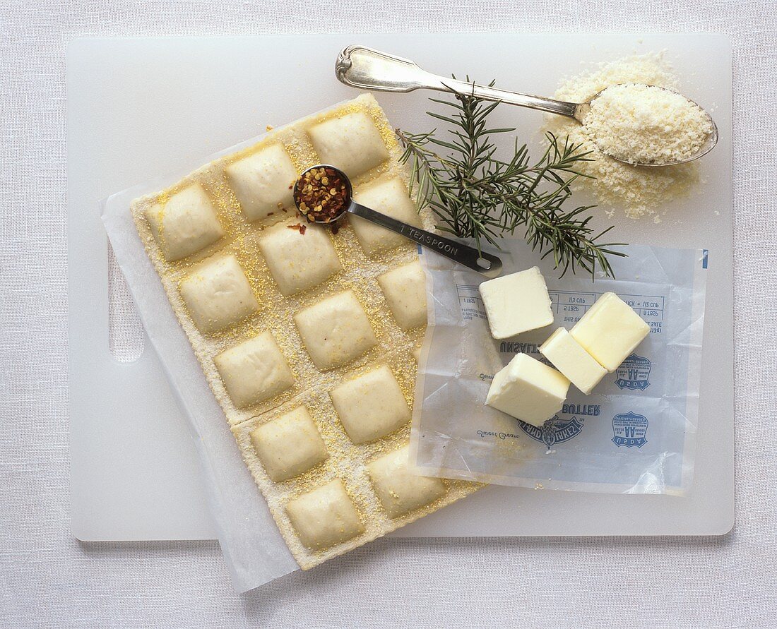 Ravioli with ingredients (chilli, butter, rosemary, Parmesan)