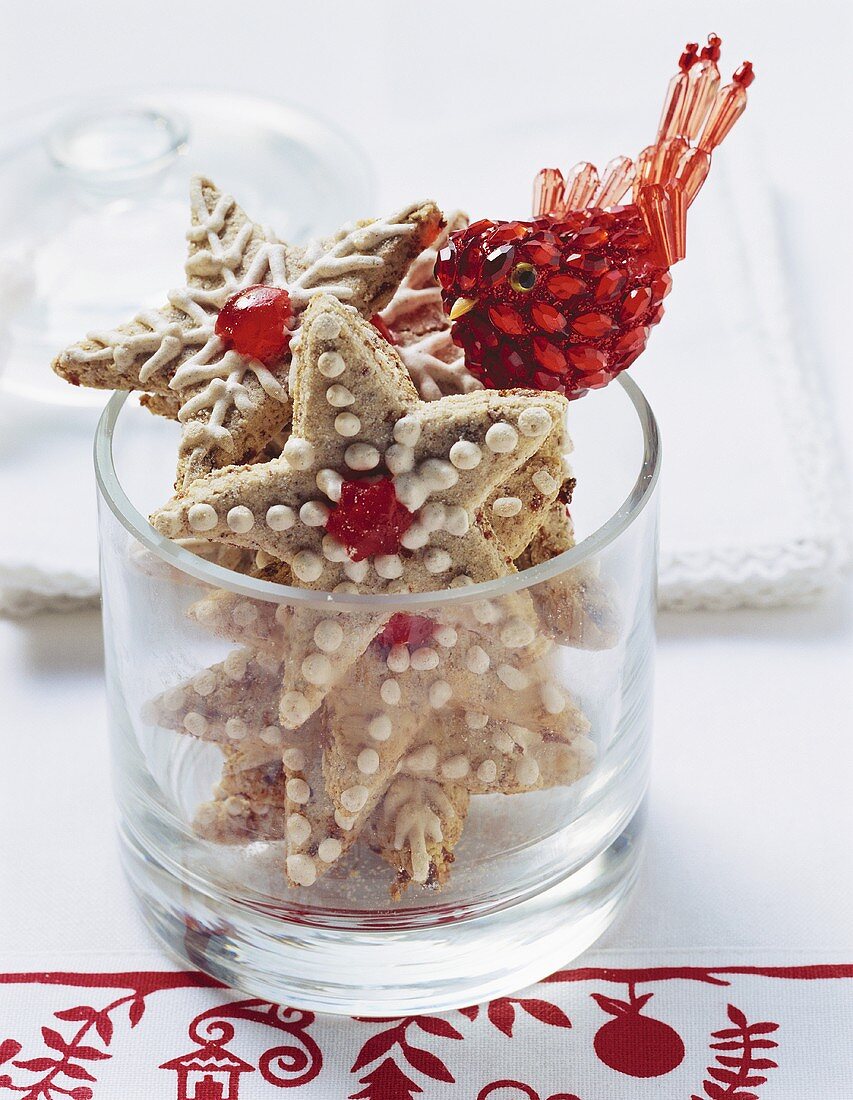 Cinnamon stars with cherries in glass