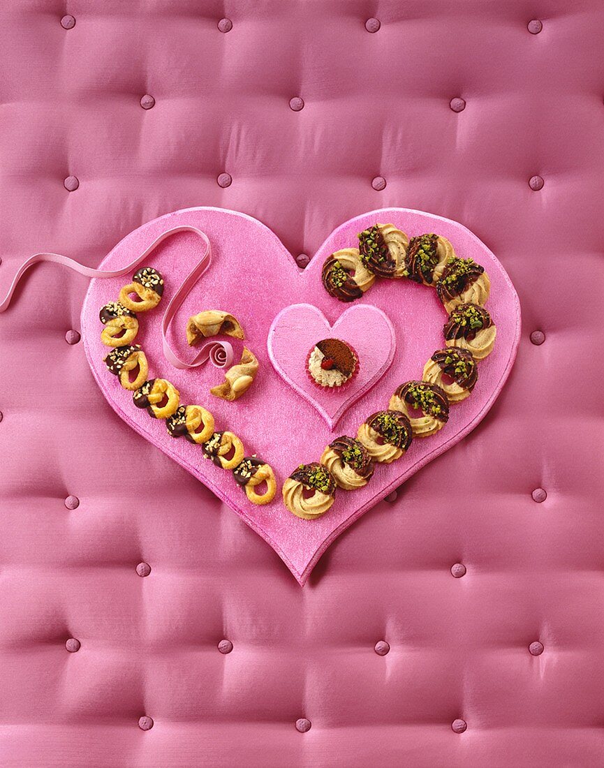 Almond pretzels and chestnut rings on heart-shaped tray