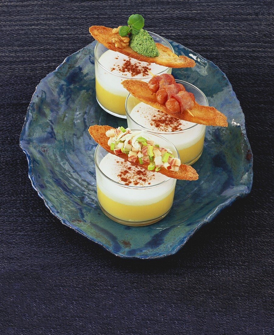 Potato soup with milk foam and toast with three toppings