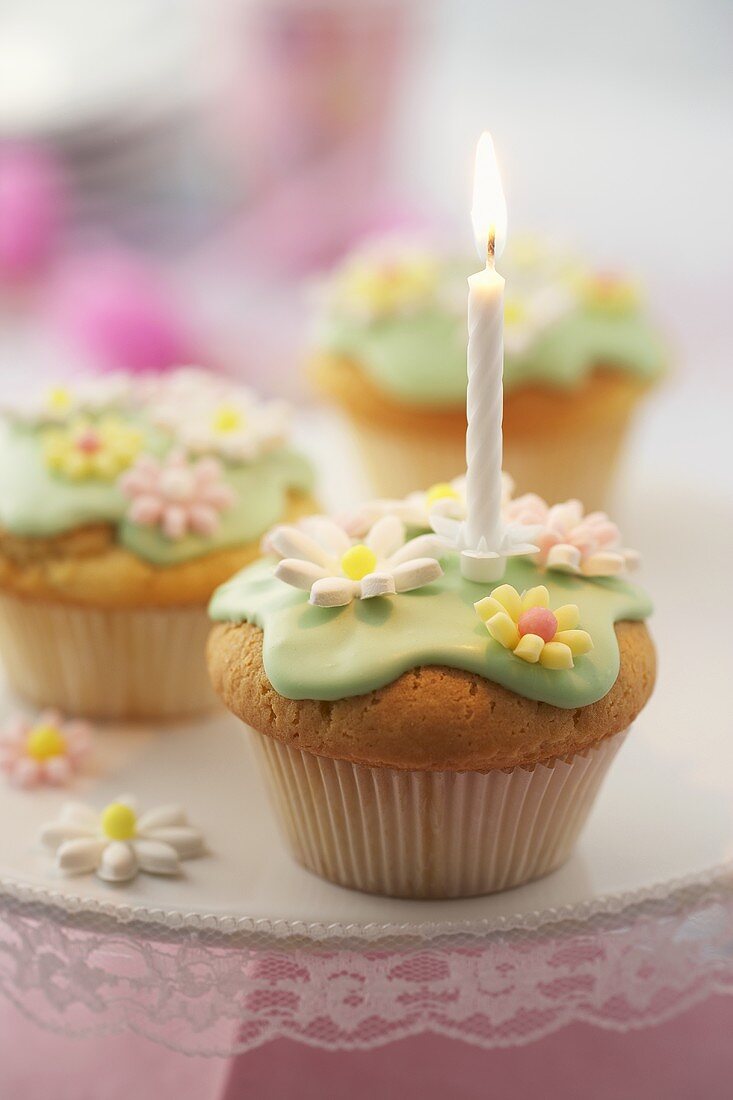 Birthday candle on muffin with sugar flowers