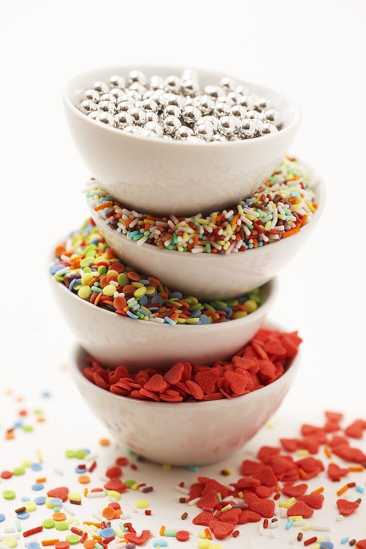 Four bowls of sprinkles (dragees, sugar hearts etc.)