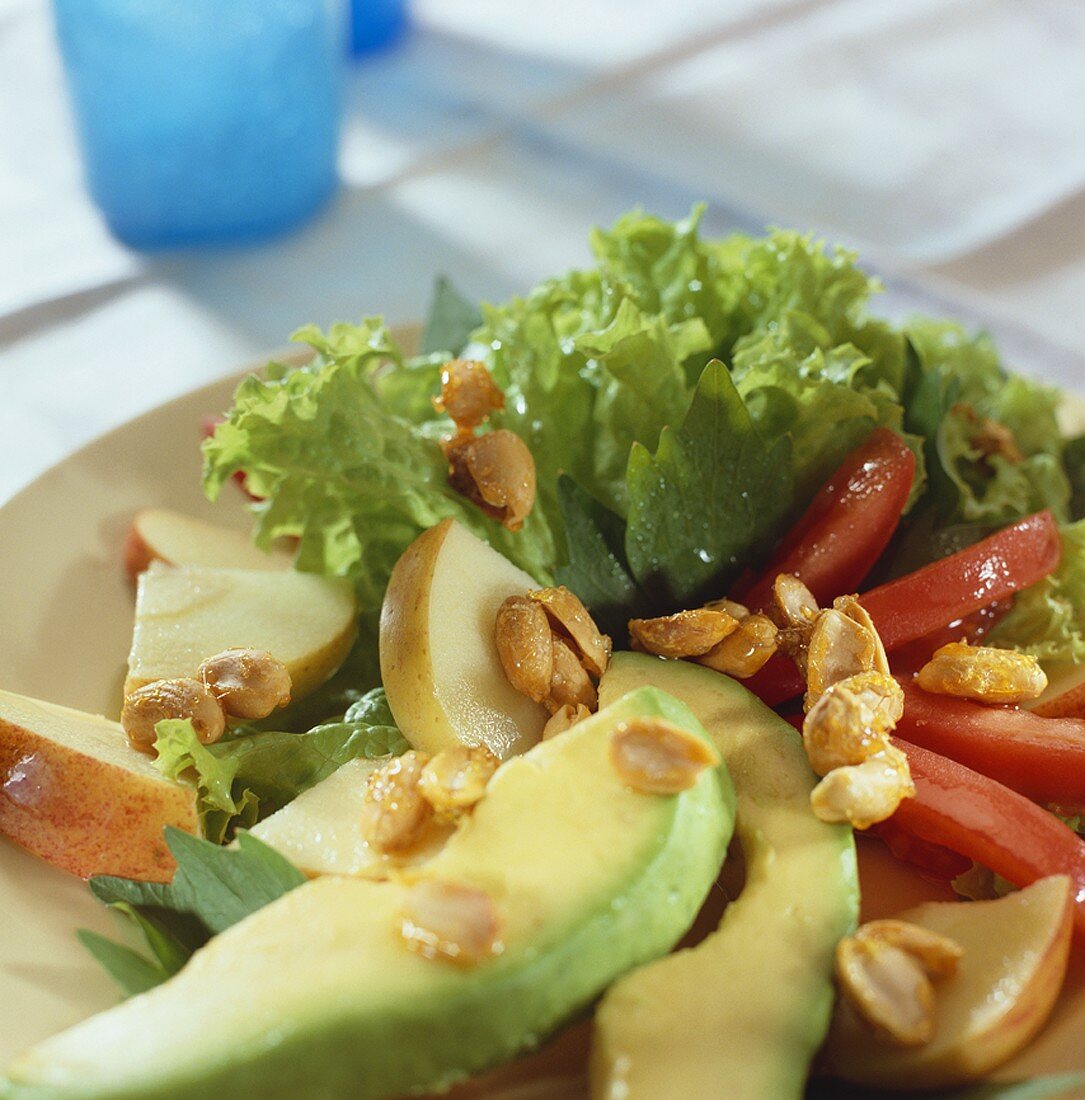 Summer salad with avocado, tomato and peanuts