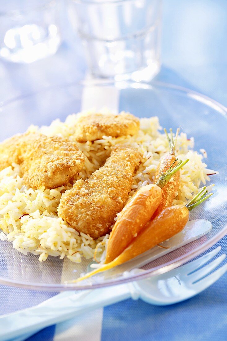 Breaded chicken pieces with rice and carrots