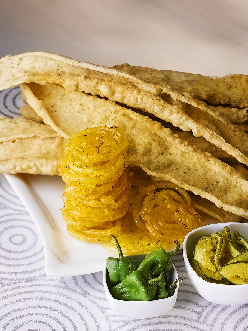 Fafda (chick-pea snacks) with jalebis, chillies and papaya