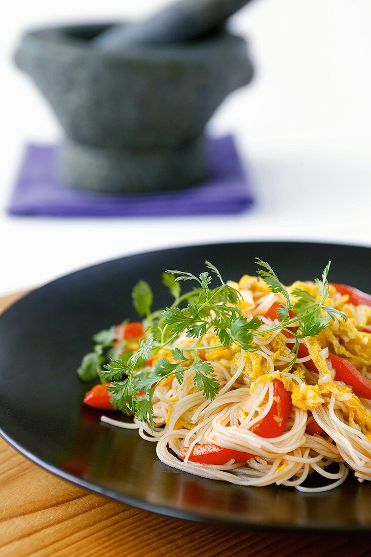 Rice noodles with red peppers and fresh coriander (Asia)