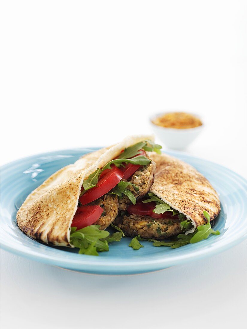 Pita bread filled with lentil burgers and salad