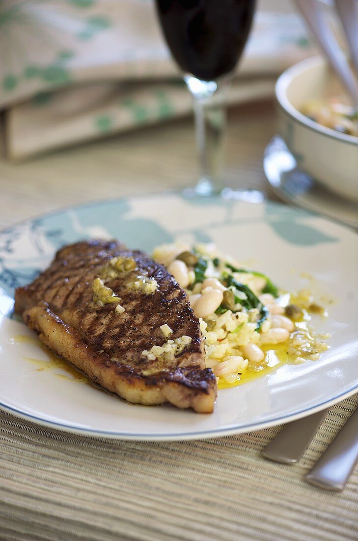 Grilled veal steak with beans
