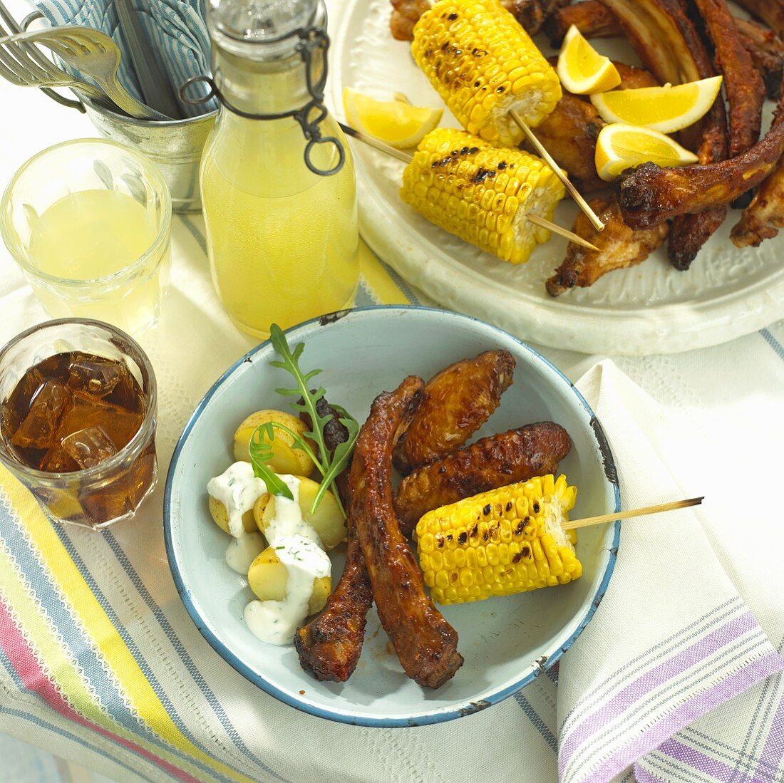 Barbecued ribs and corn on the cob, drinks