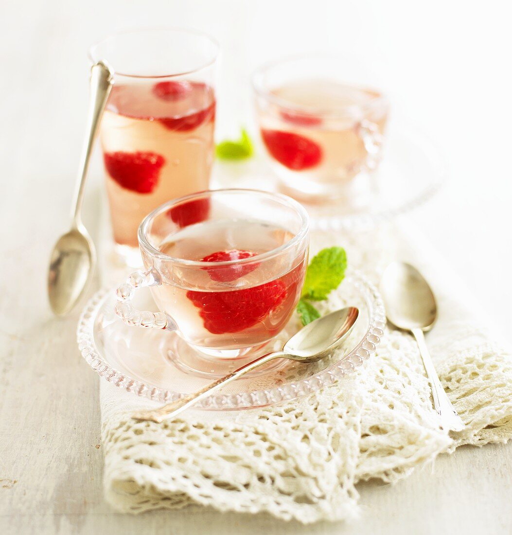 Elderflower jelly with raspberries in cups and glass