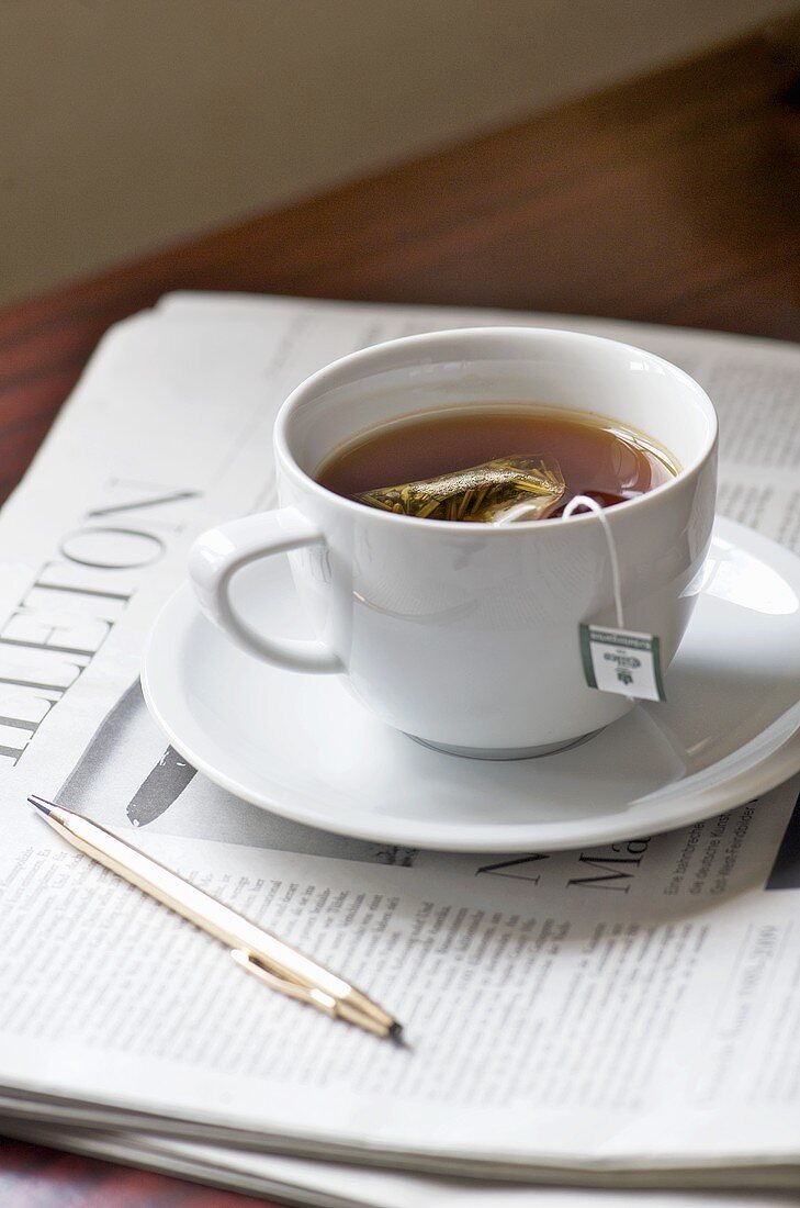 Cup of herbal tea on a newspaper