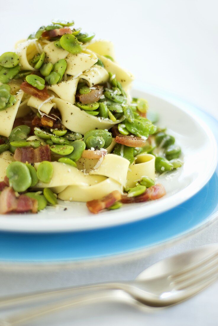 Ribbon pasta with bacon and broad beans