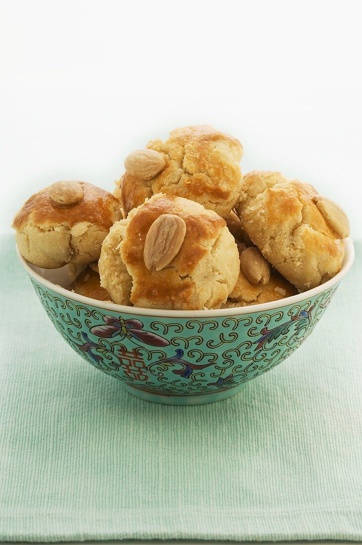 Several almond biscuits in Chinese bowl