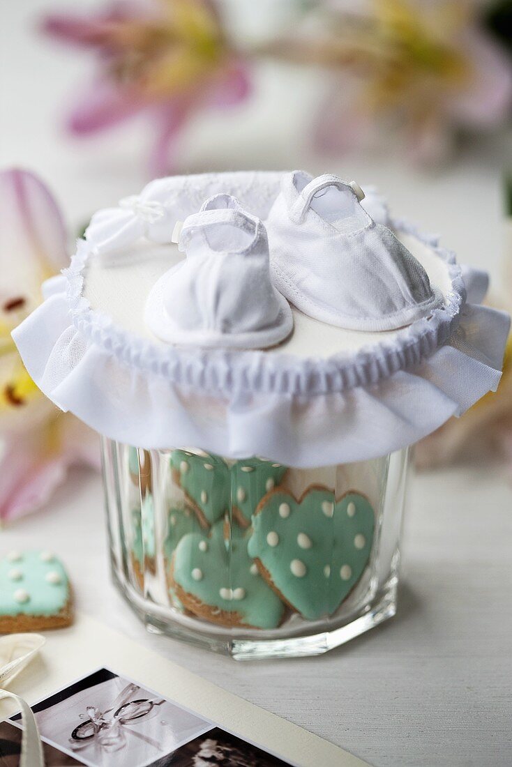 Baby shoes on biscuit jar