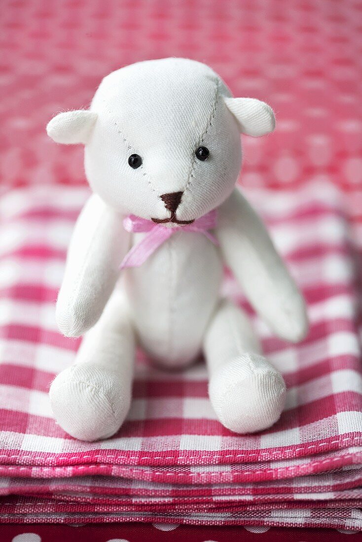 Teddy bear on checked cloth