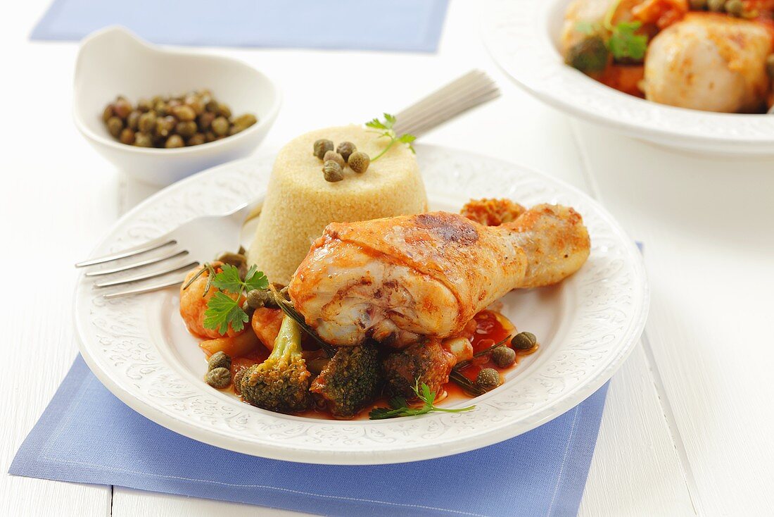 Chicken drumstick with broccoli, tomato sauce and couscous