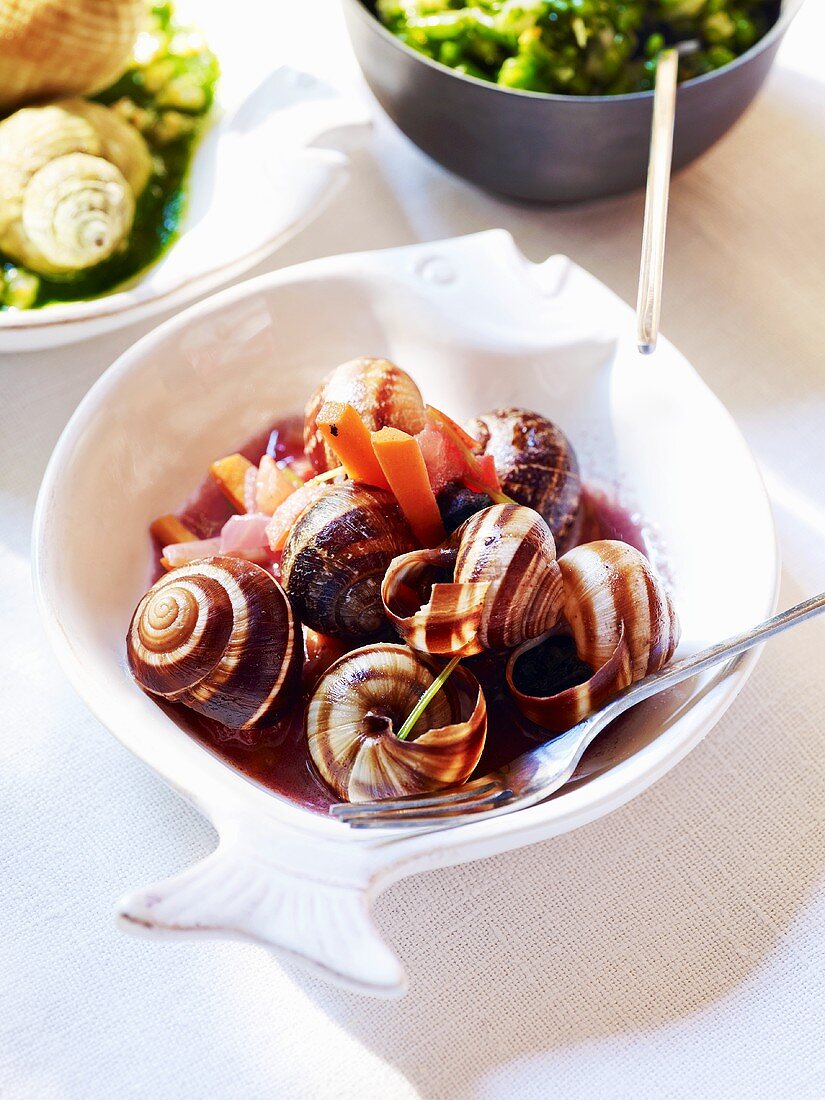 Snails and carrots in red wine sauce