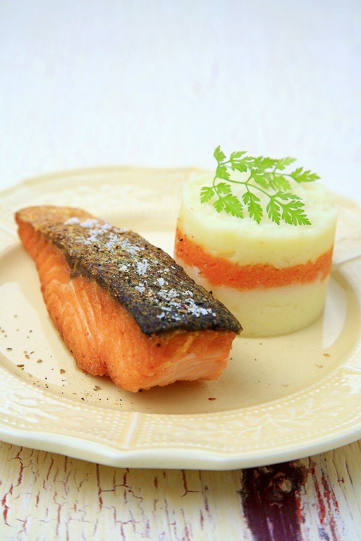 Fried salmon fillet with mashed potato and vegetable puree