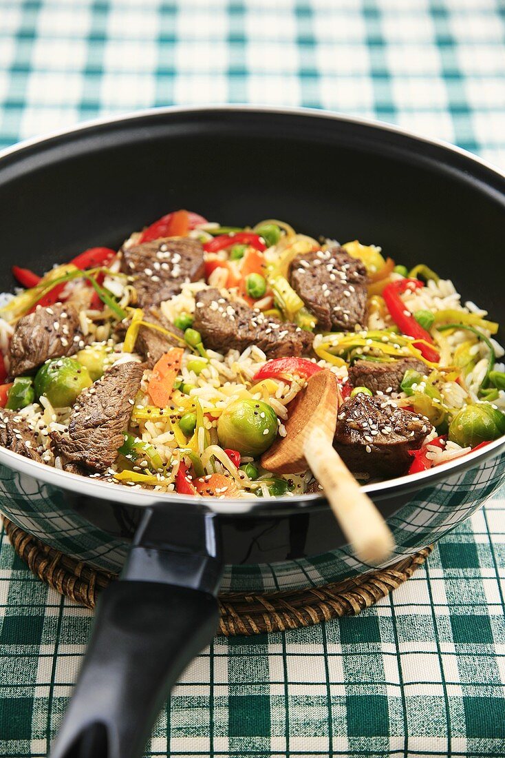 Beef and vegetables with sesame seeds in wok