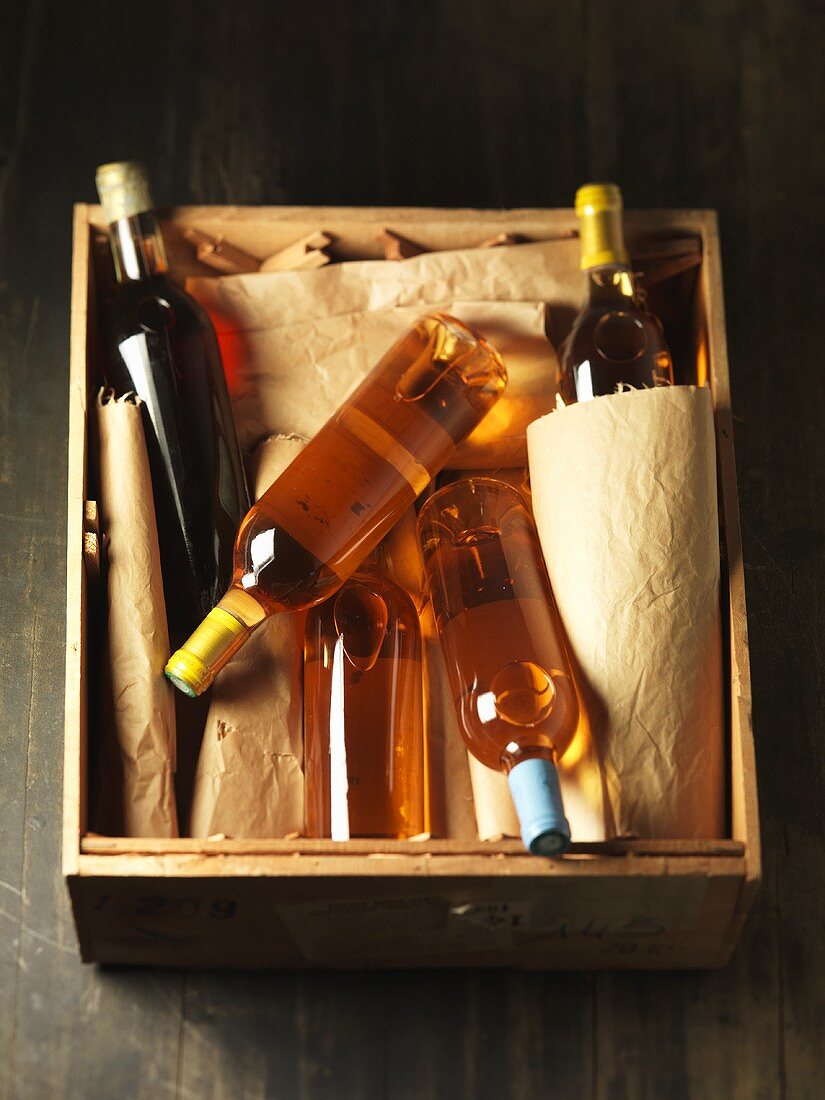 Several bottles of white wine in wooden box