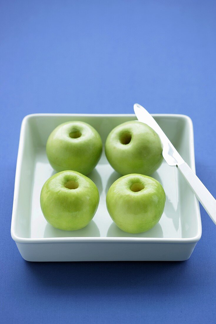 Four green apples, cored