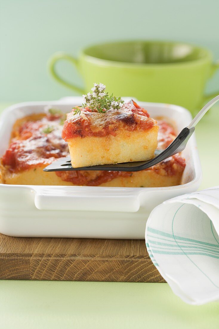 Baked polenta with tomato sauce, Parmesan and rosemary