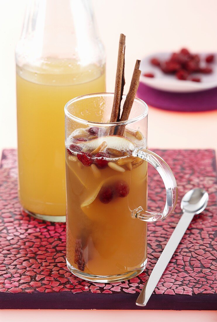 Apple and pear punch with dried cranberries and toasted pine nuts