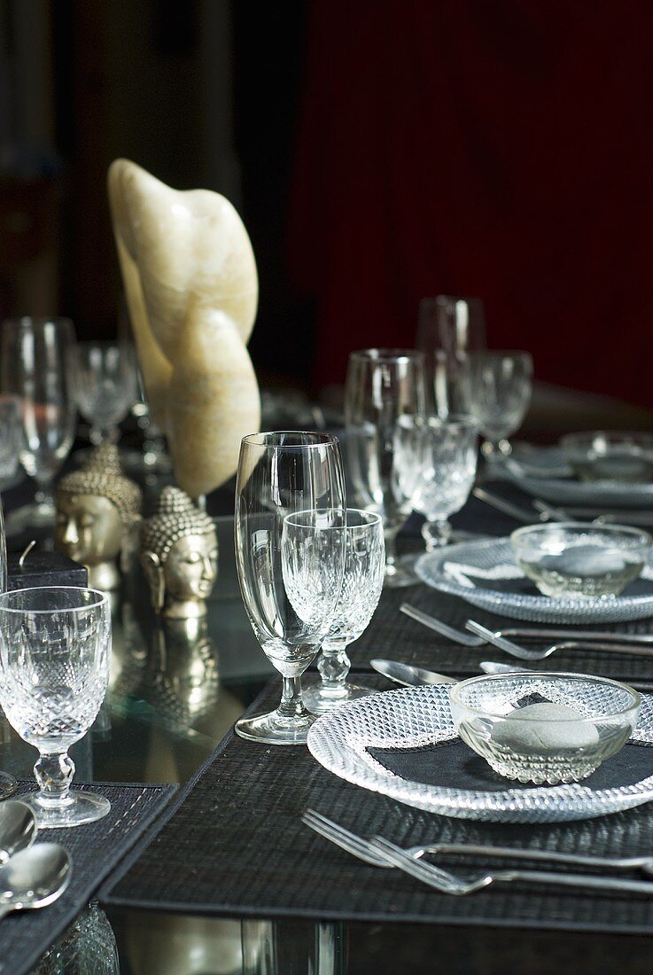 Laid table with glass tableware and Asian decorations