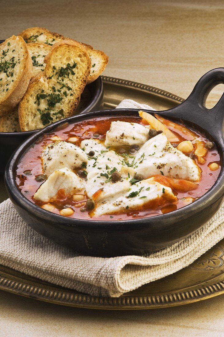 Fish stew with chick-peas, toasted bread