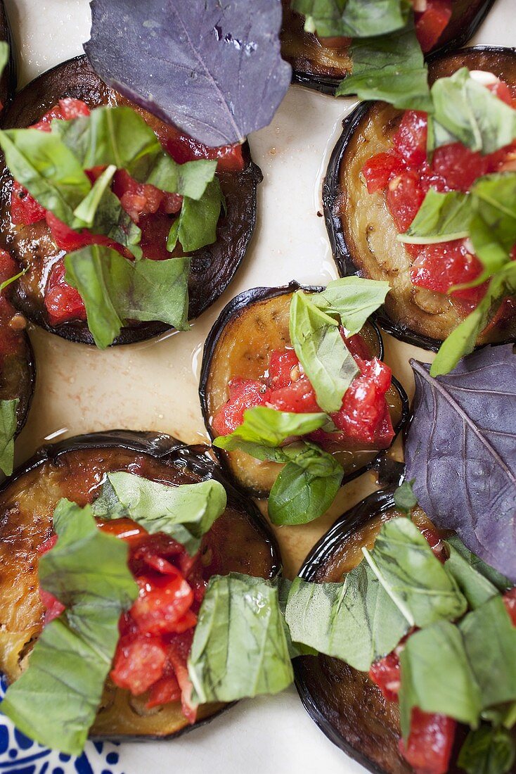 Marinated aubergine slices with tomato and basil