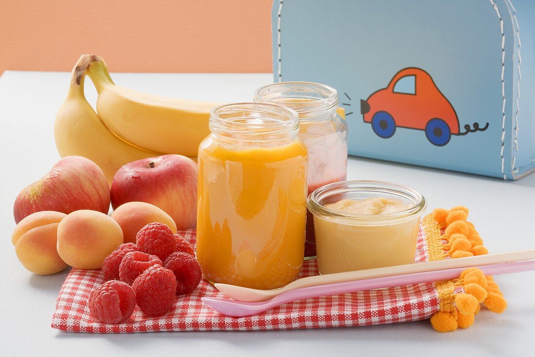 Baby food in jars and fresh fruit