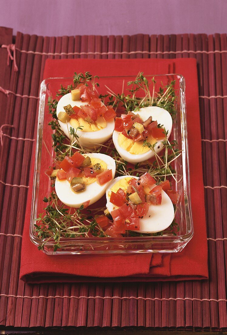 Halved boiled eggs with salsa