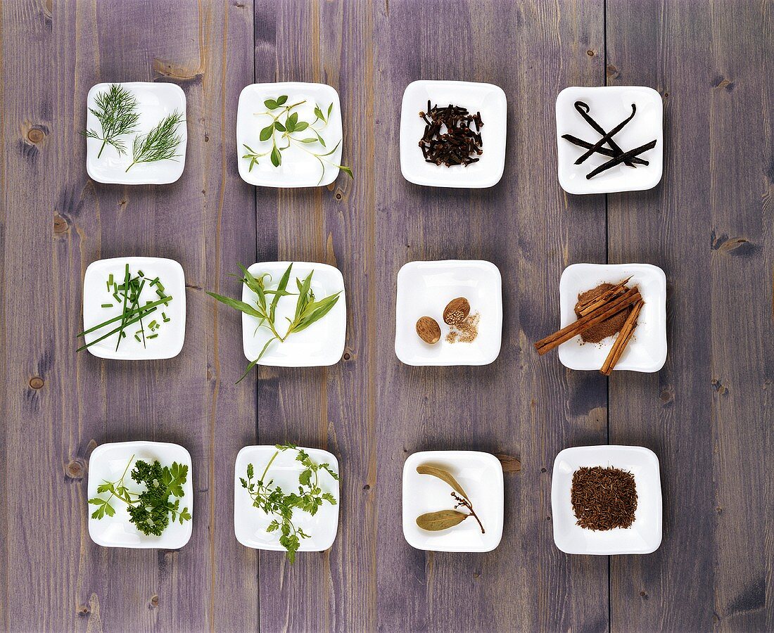 An assortment of herbs and spices in small bowls