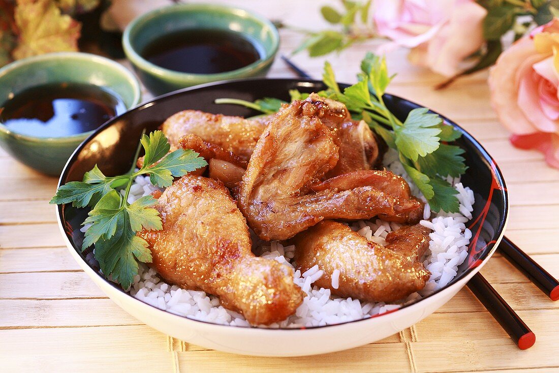 Chicken legs and wings on rice with soy sauce