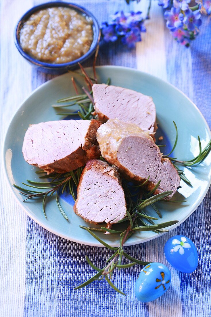 Slices of loin of pork on rosemary