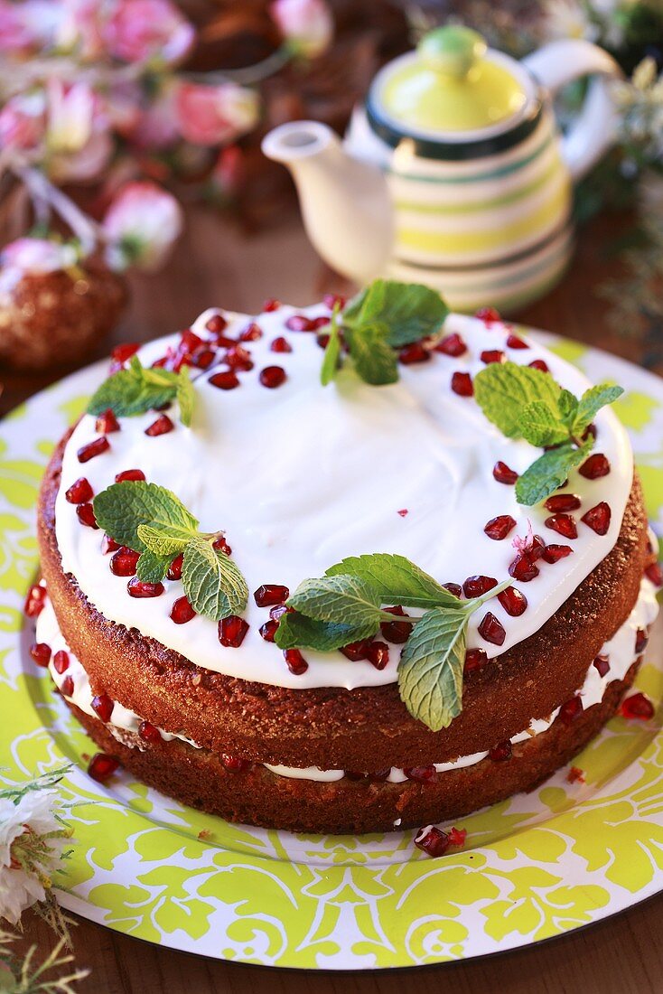 Cake with yoghurt filling and pomegranate seeds