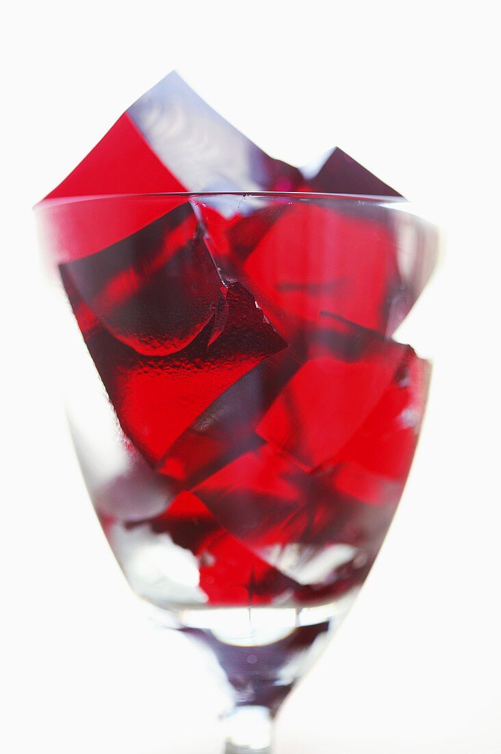 Cubes of raspberry jelly in a glass